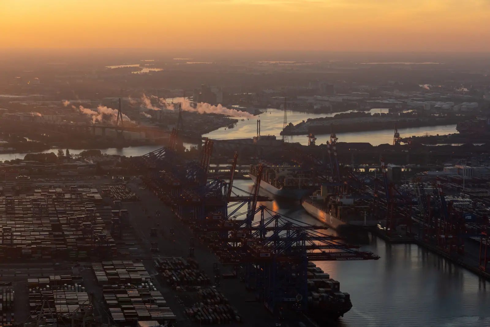 Aerial view of a container terminal and vessels at sunrise in Hamburg